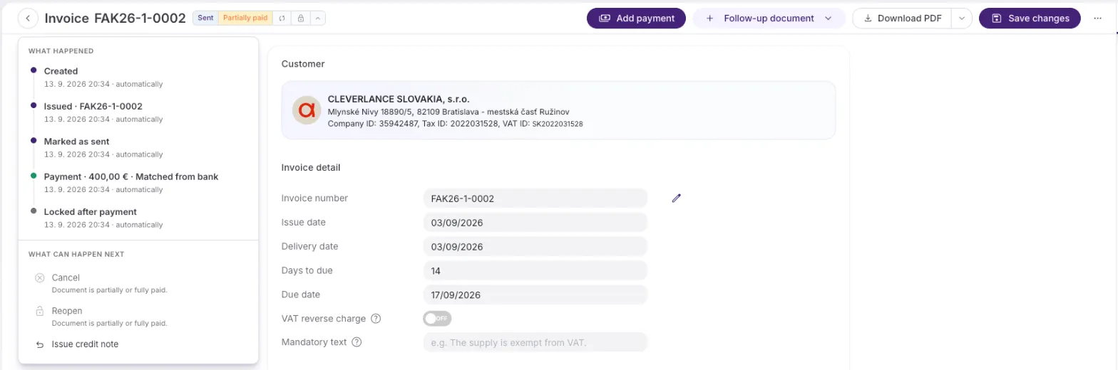 An invoice with four badge segments (Sent, Partially paid, a bank-matched icon and a padlock) and the panel open, where Cancel and Reopen are greyed out with their reason and Issue credit note remains.